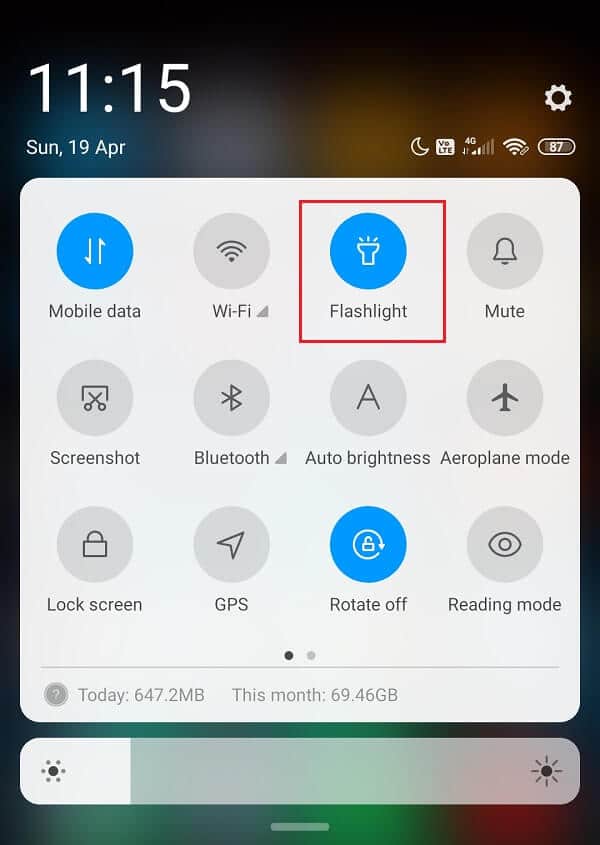 Pull down your notification bar, enable the flashlight by pressing on the flashlight icon