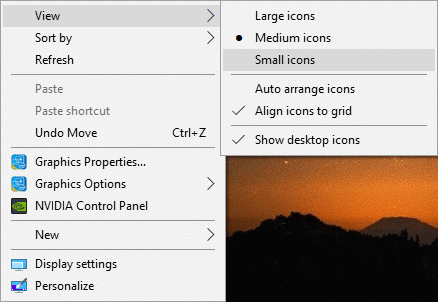 Right-click on the desktop then select View and change the view from your currently selected view to any other