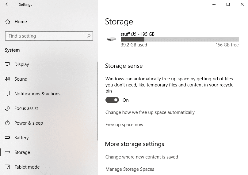 Select Storage from the left pane and scroll down to Storage Sense